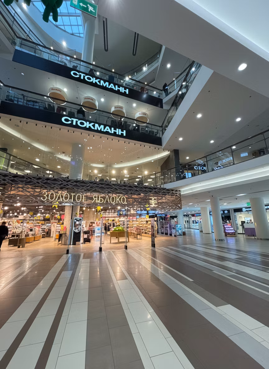 Zu Fa – Remove all people from this shopping mall interior photo. Keep the architecture, stores, escalators, glass balconies,…