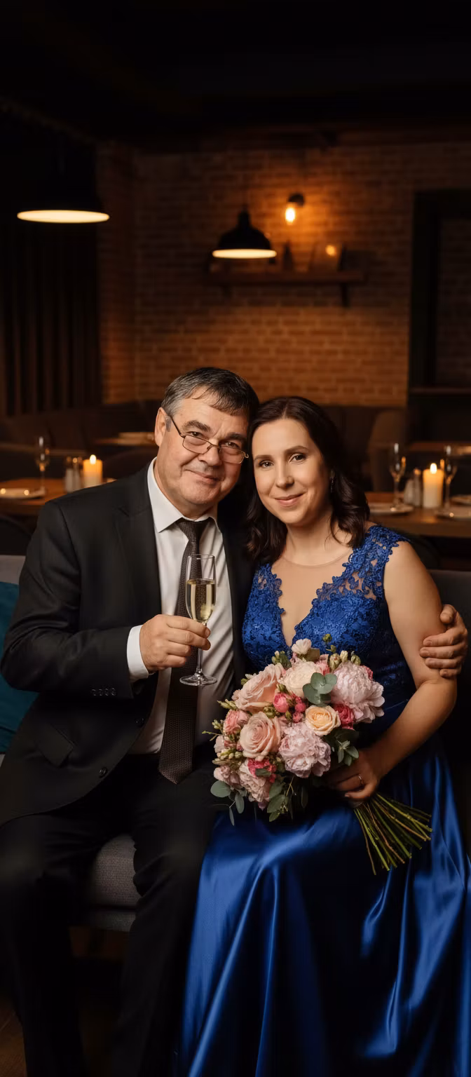 Лариса Примоченко – Transform the provided photo of a couple into a romantic scene in a cozy cafe: the woman wearing an elegant evening d…