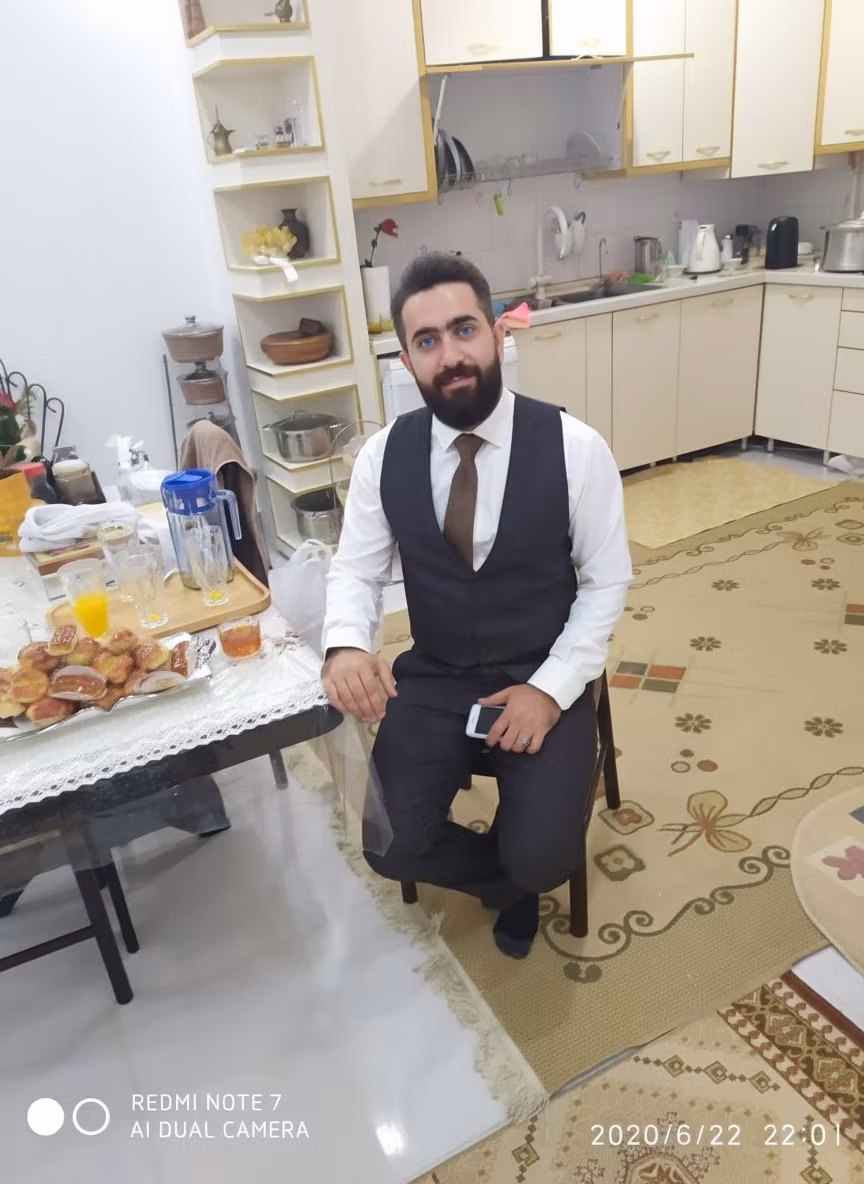 Mohsen Dalvand – Transform this man's appearance by making three specific changes: First, change his brown eyes to bright blue eyes, k…
